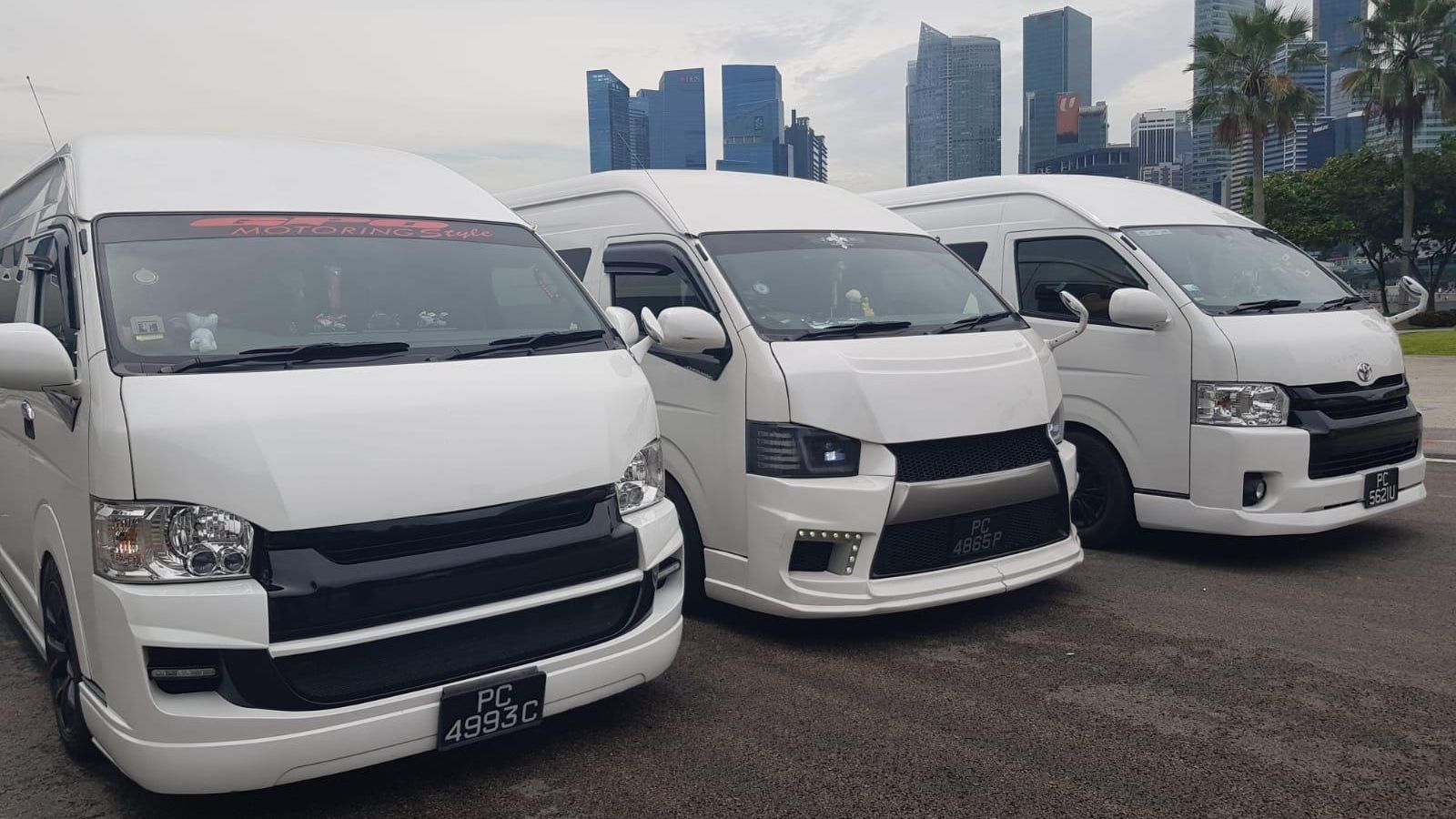 SKO Limousine maxi cabs with the Singapore city skyline behind them