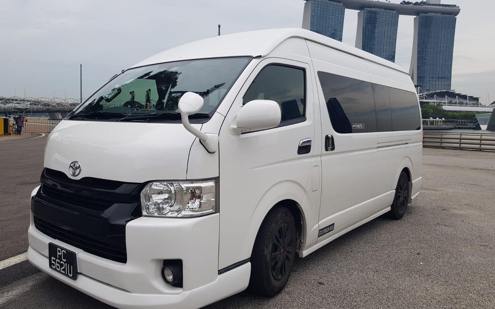 SKO 13-seater minibus parked with Marina Bay Sands in the background